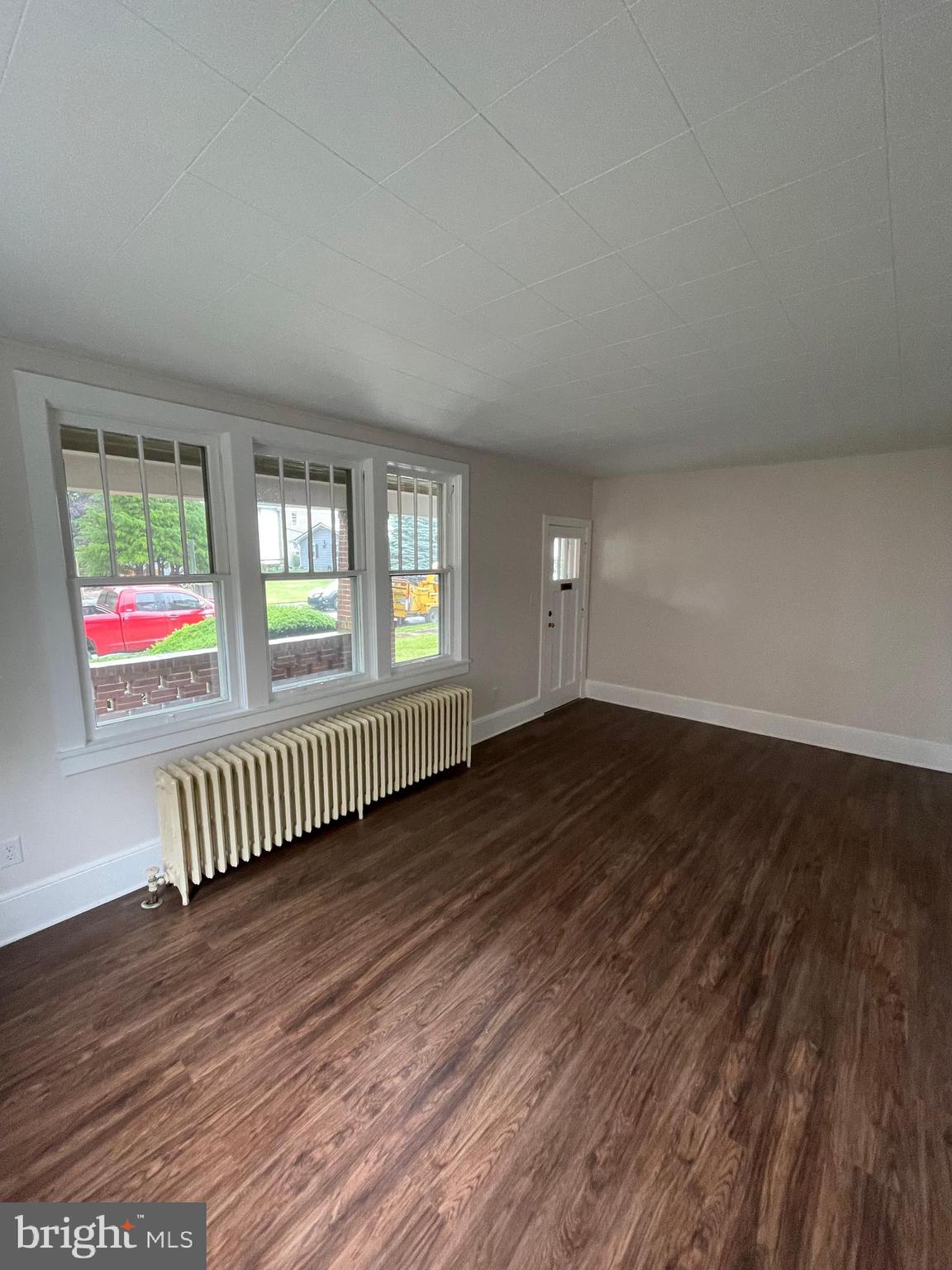 142 Riddle Road Chambersburg, PA 17201 - Photo 7 of 51 an empty room with wooden floor and windows