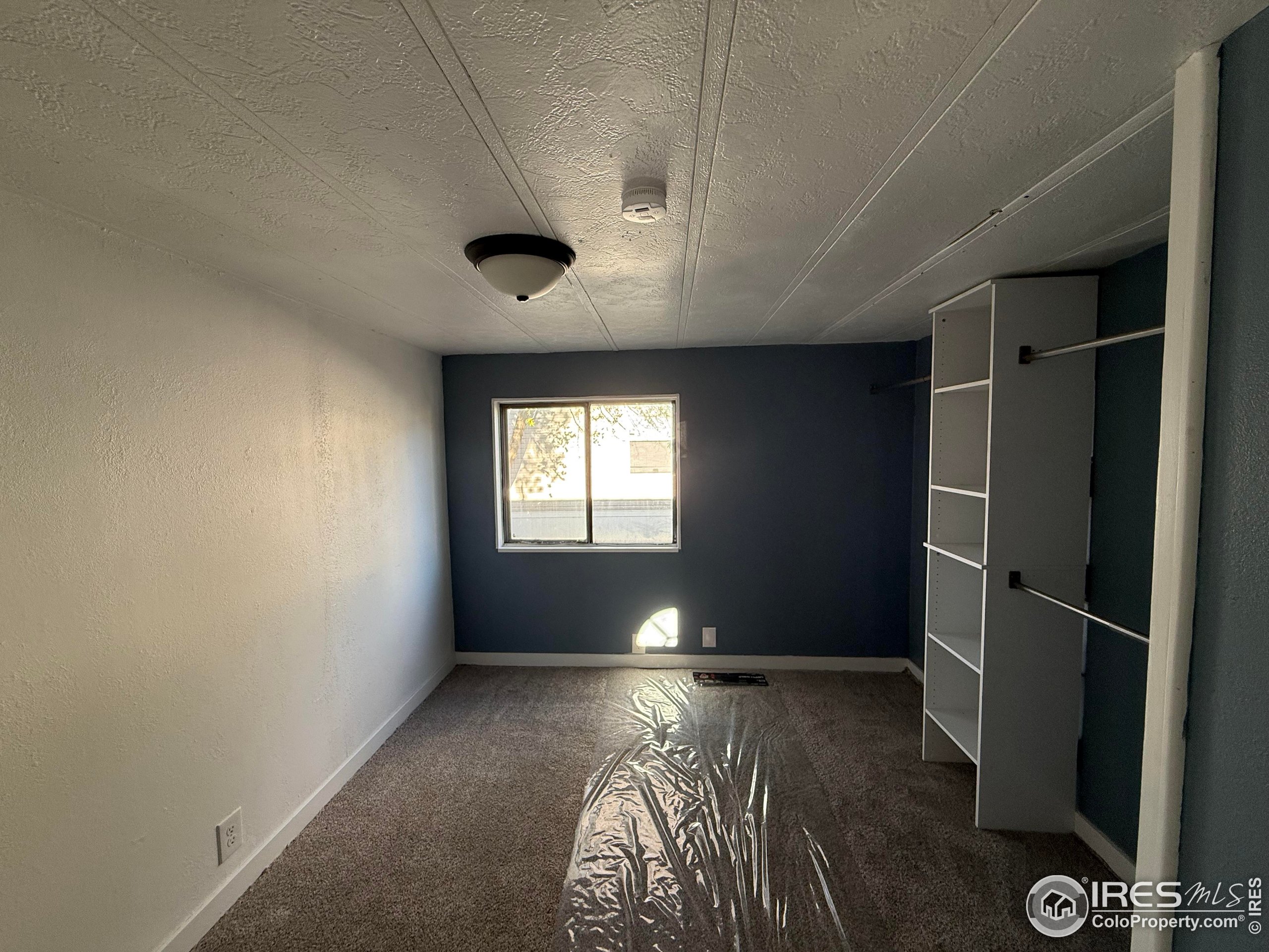 830 1st Street, Unit 23 Pierce, CO 80650 - Photo 11 of 16 a view of room with window and hardwood floor