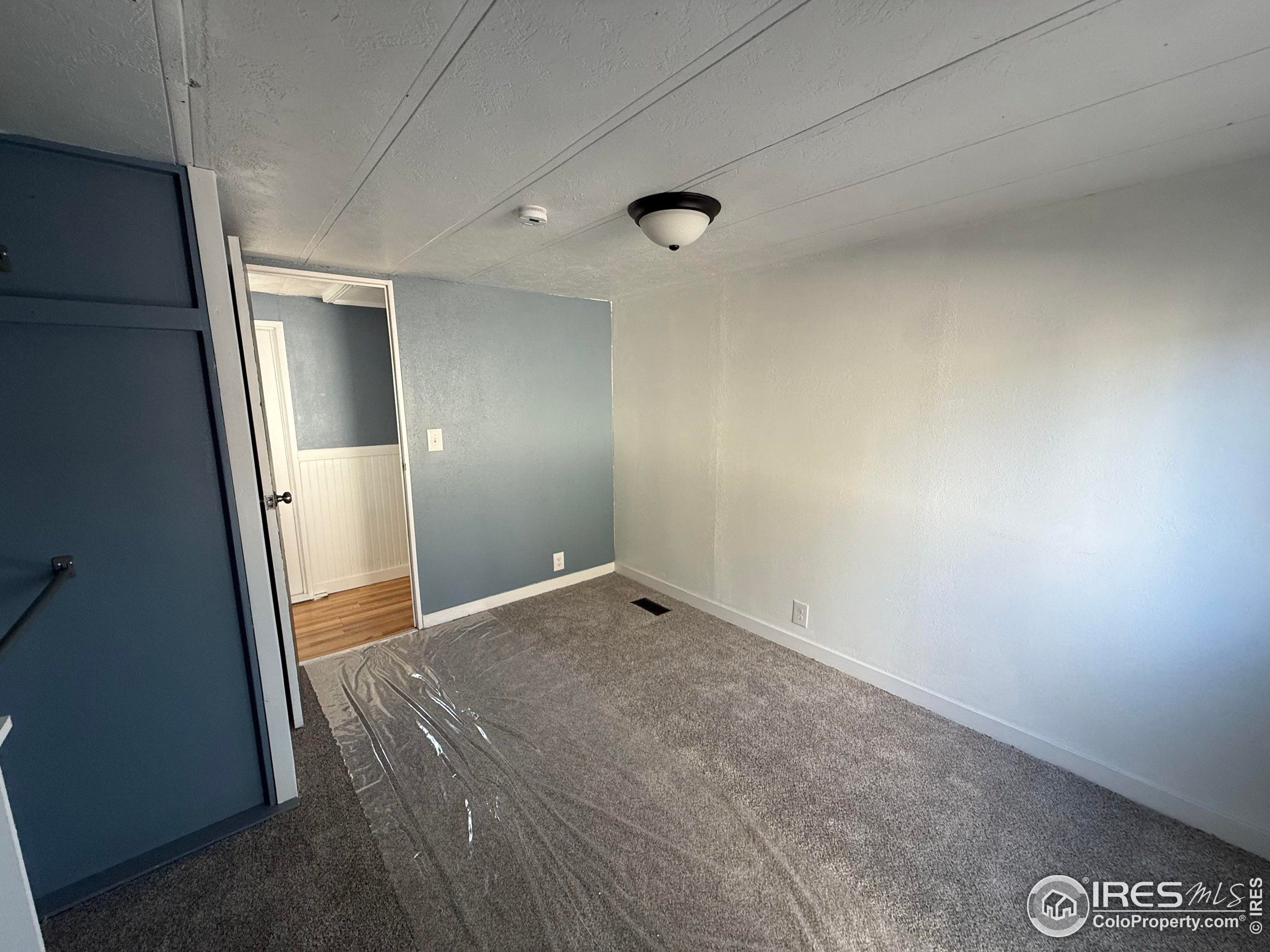 830 1st Street, Unit 23 Pierce, CO 80650 - Photo 14 of 16 an empty room with a mirror