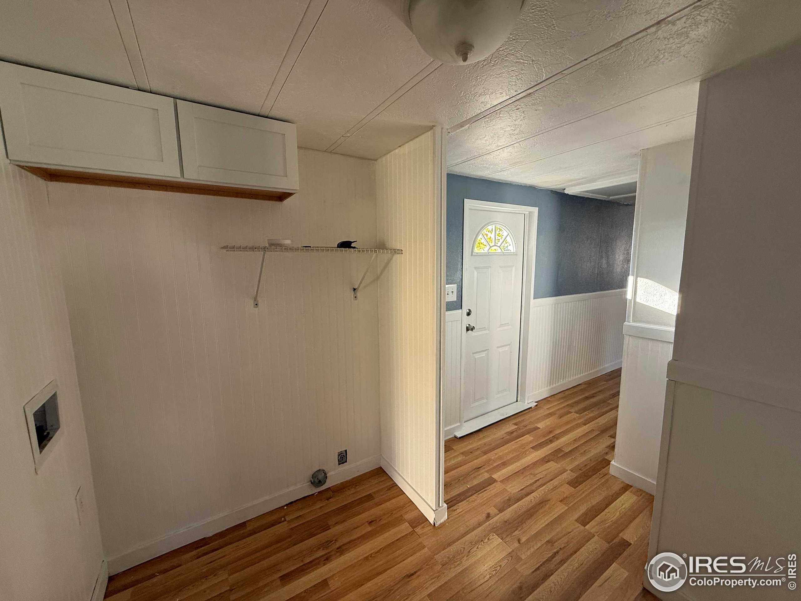 830 1st Street, Unit 23 Pierce, CO 80650 - Photo 15 of 16 a view of a hallway with wooden floor