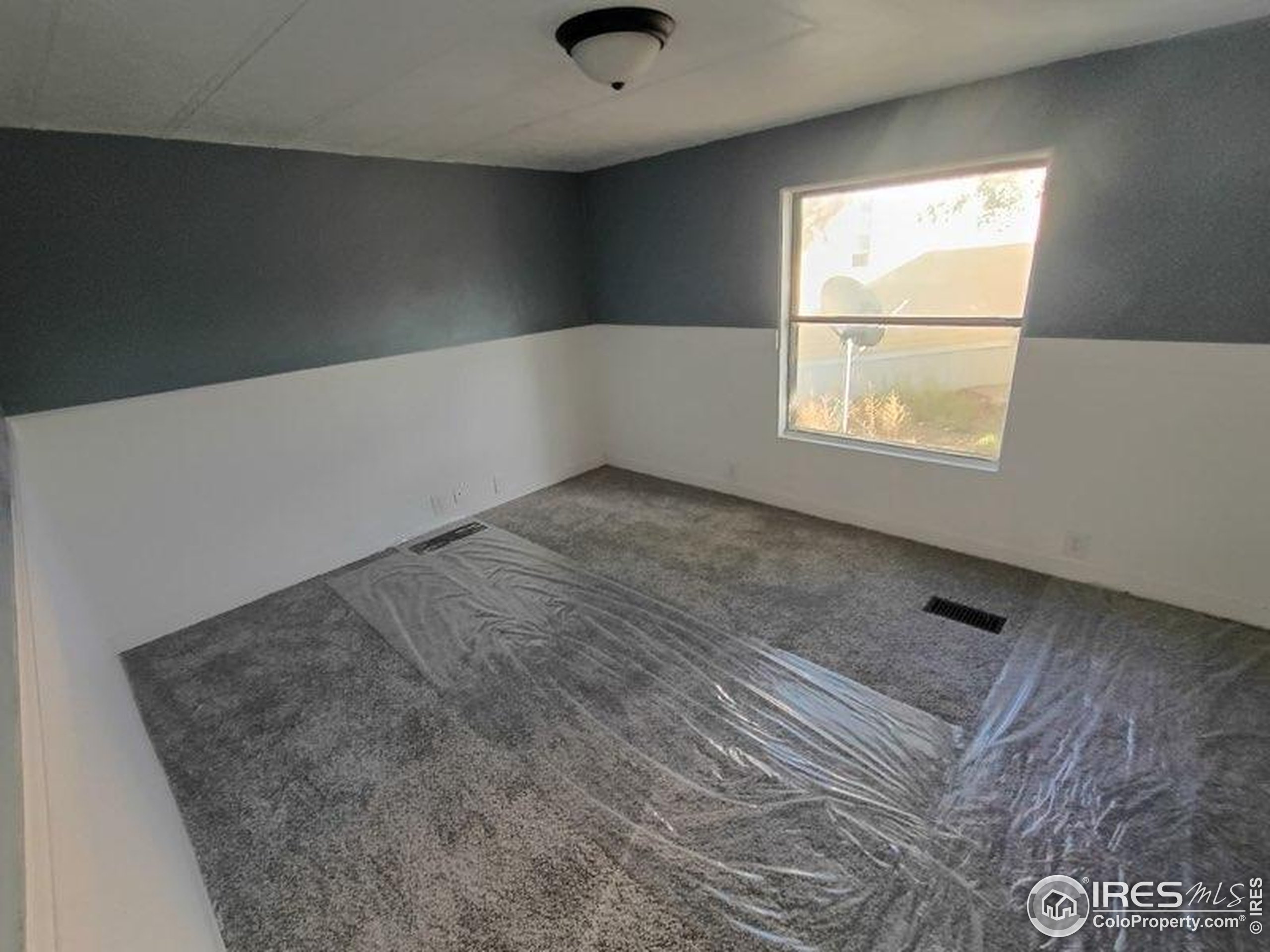 830 1st Street, Unit 23 Pierce, CO 80650 - Photo 9 of 16 a view of an empty room and window