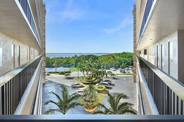 a kitchen with a refrigerator and white cabinets