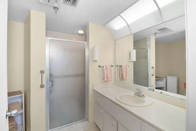 a view of staircase with lots of frames on wall and a large window