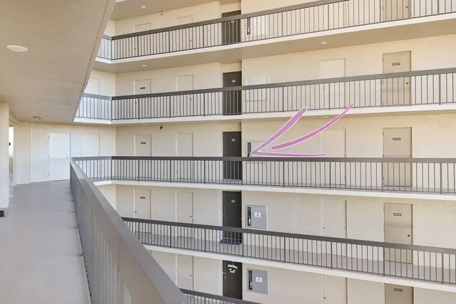 a view of a kitchen with a sink and dishwasher with white doors