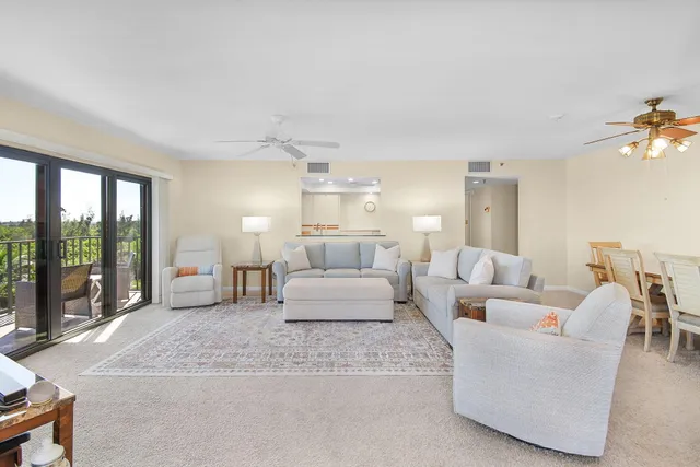a living room with furniture and floor to ceiling window