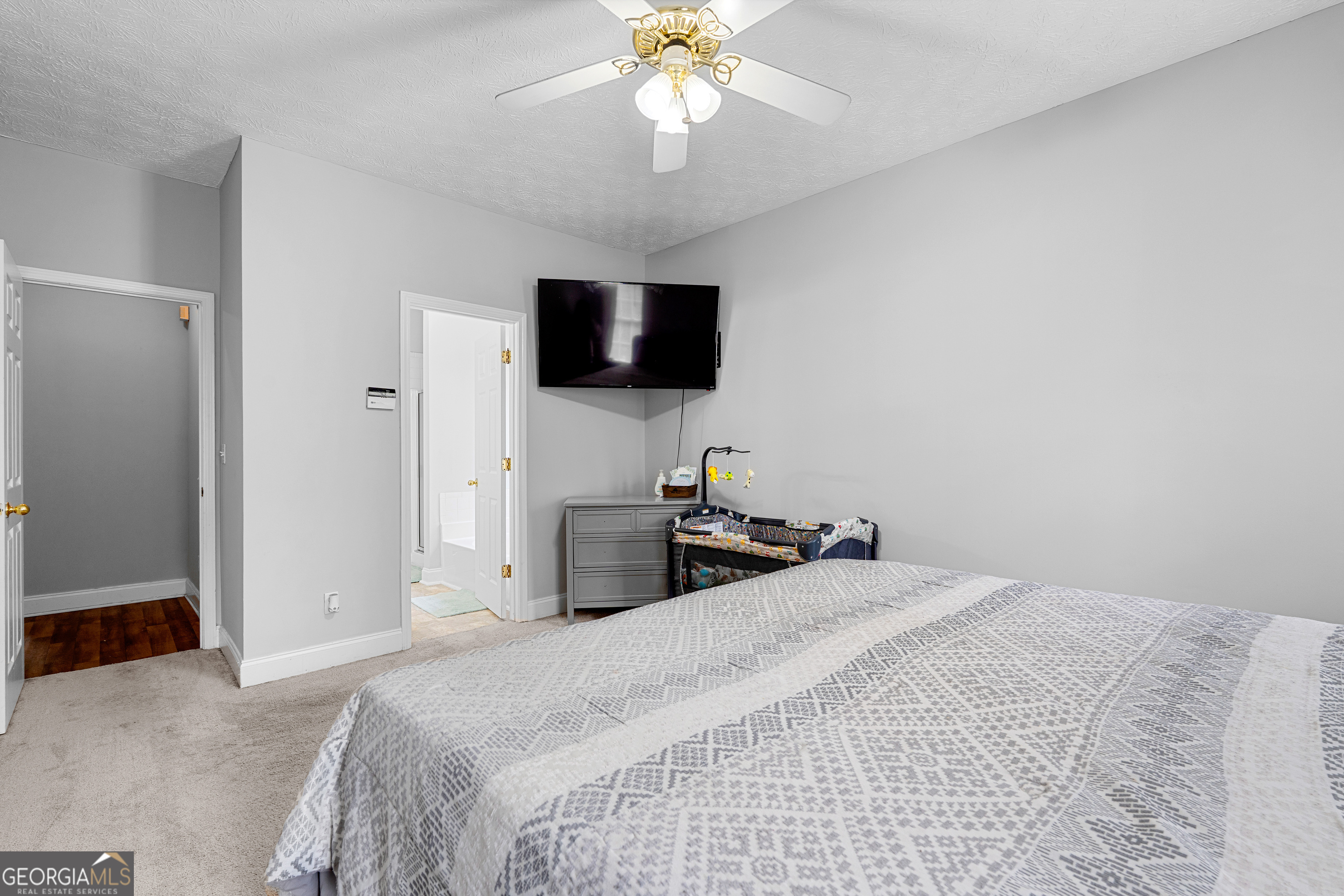 35 South Robin Lane Newnan, GA 30263 - Photo 18 of 50 a bedroom with a bed and a flat screen tv