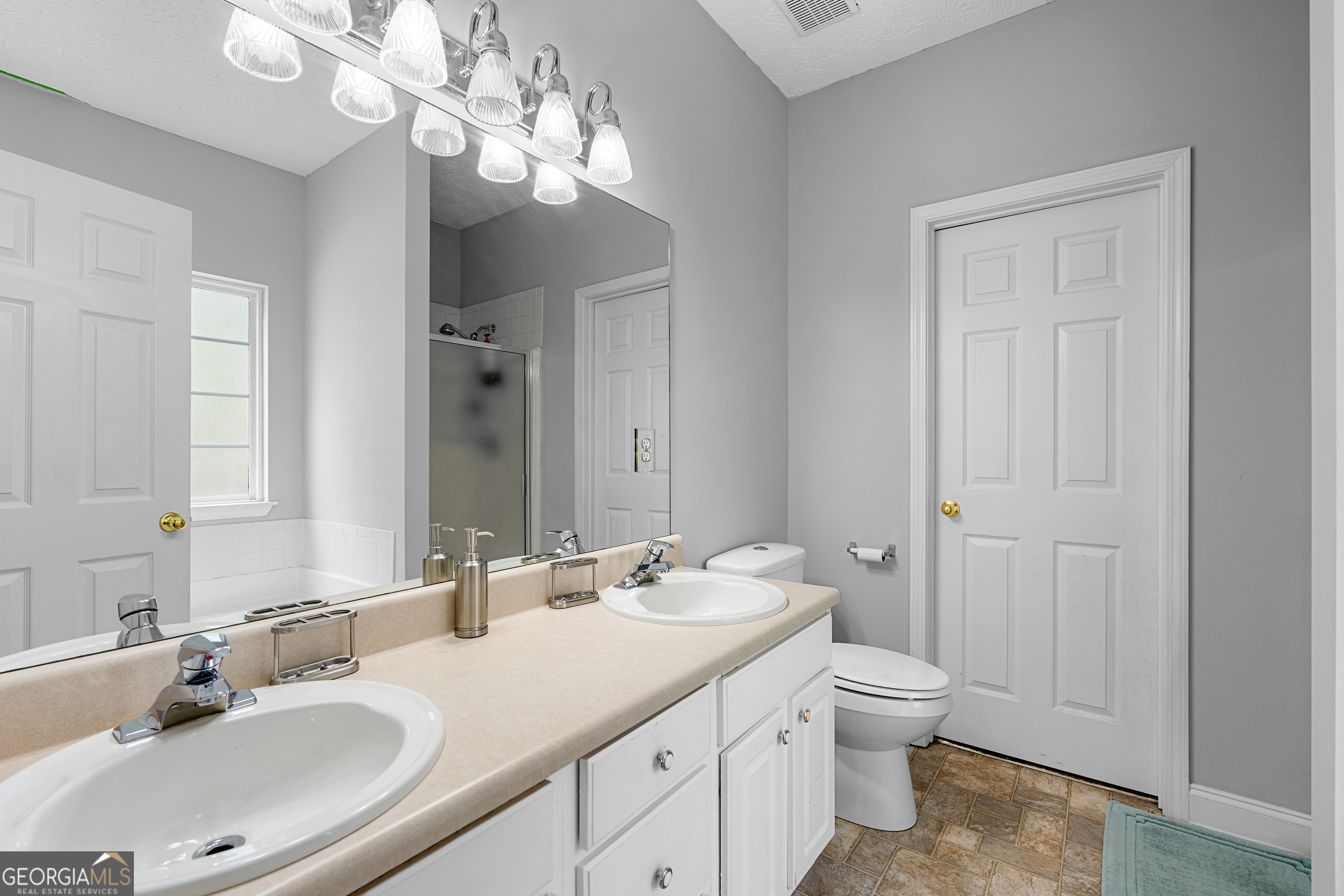 35 South Robin Lane Newnan, GA 30263 - Photo 19 of 50 a bathroom with a double vanity sink and a mirror