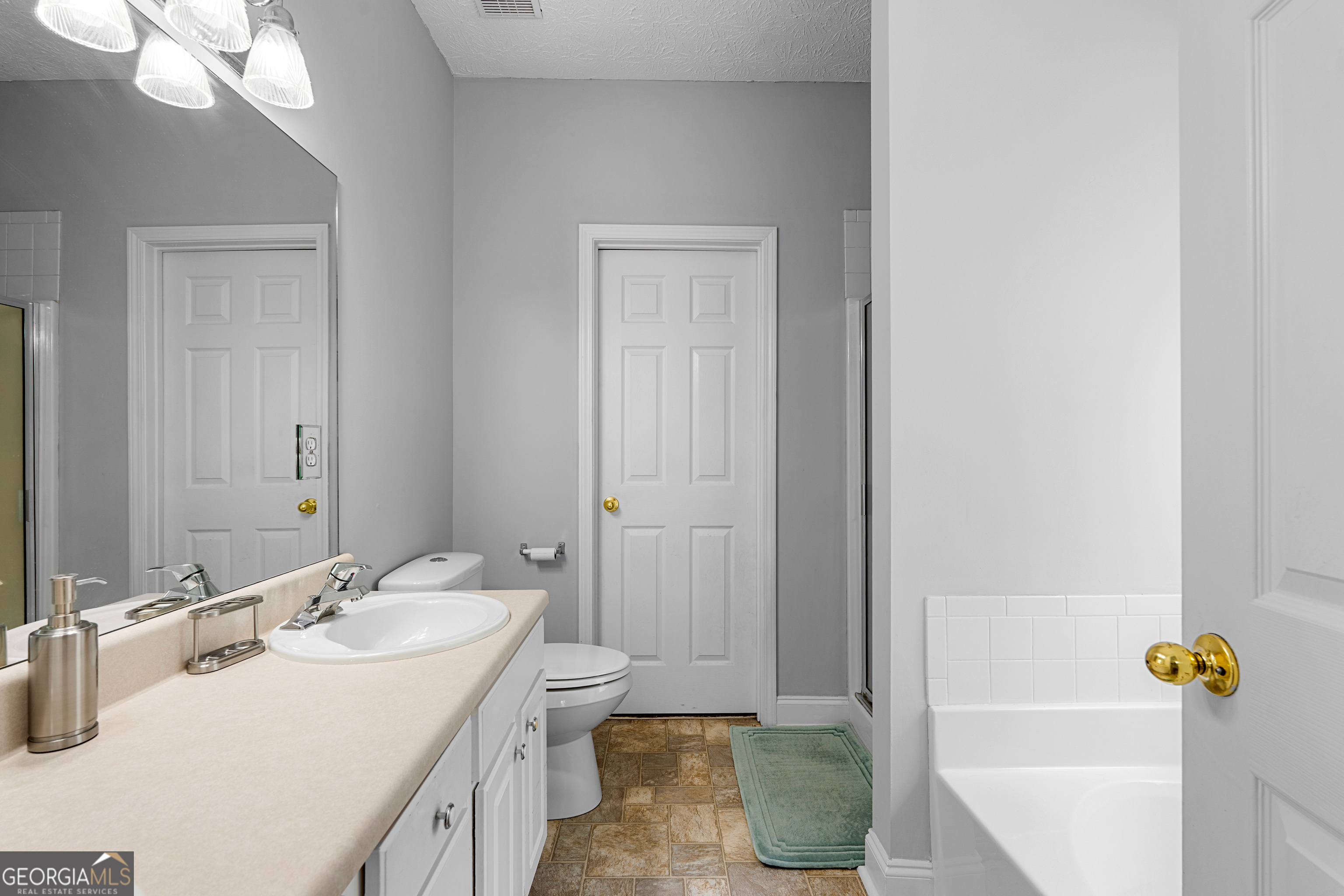35 South Robin Lane Newnan, GA 30263 - Photo 20 of 50 a bathroom with a granite countertop sink and a mirror