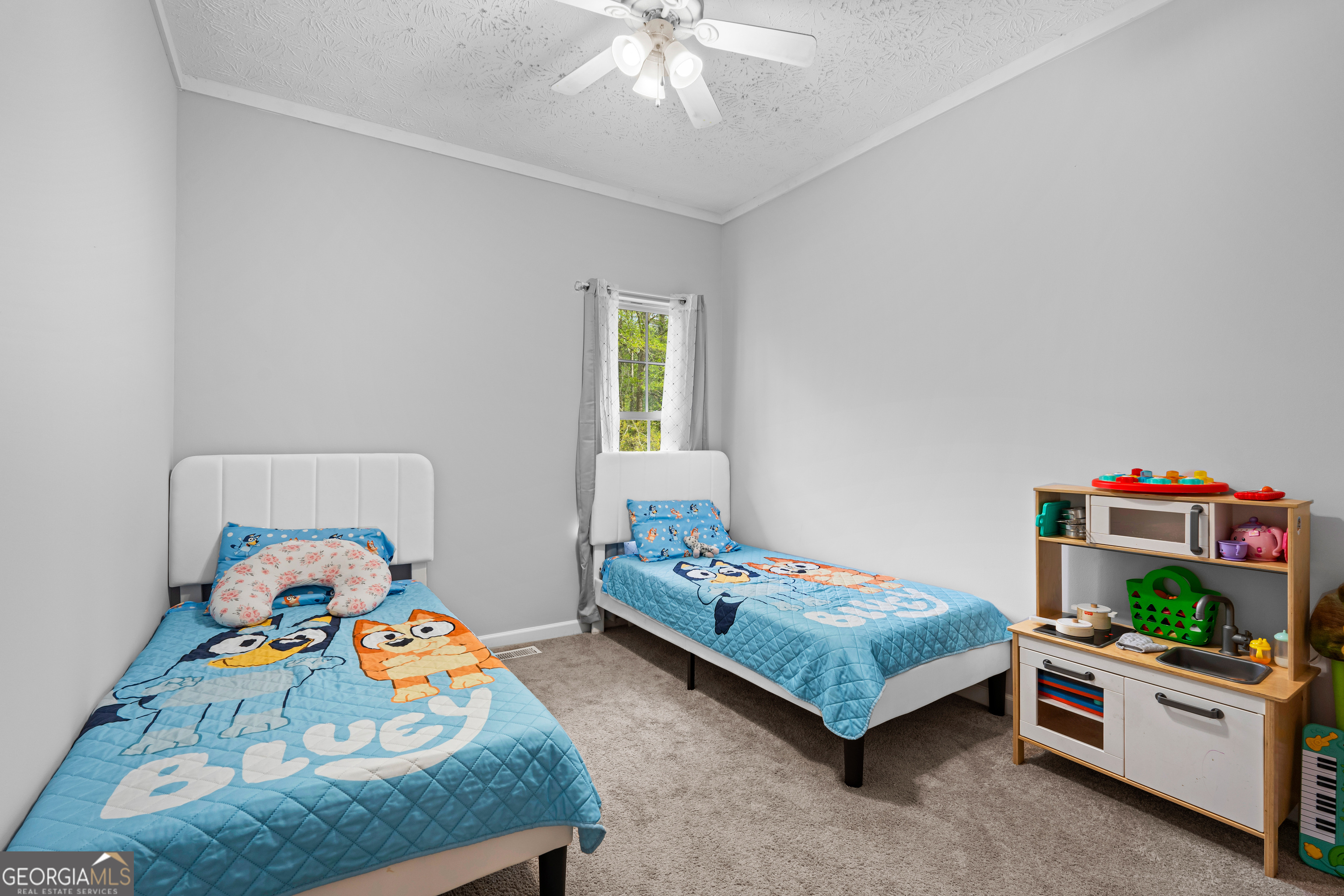 35 South Robin Lane Newnan, GA 30263 - Photo 24 of 50 a bedroom with a bed and a baby bed