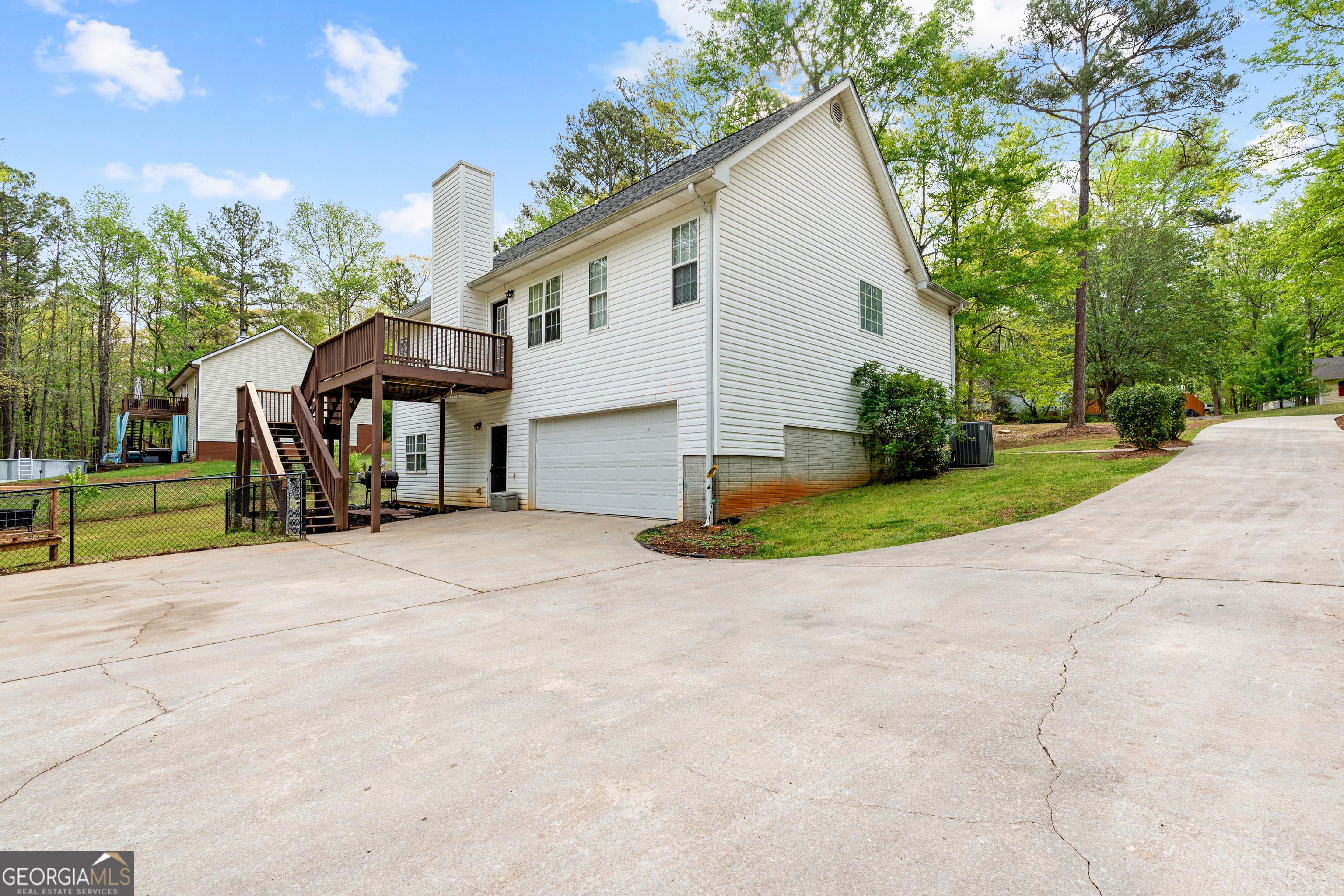 35 South Robin Lane Newnan, GA 30263 - Photo 46 of 50 a view of a white house with a yard plants and large tree