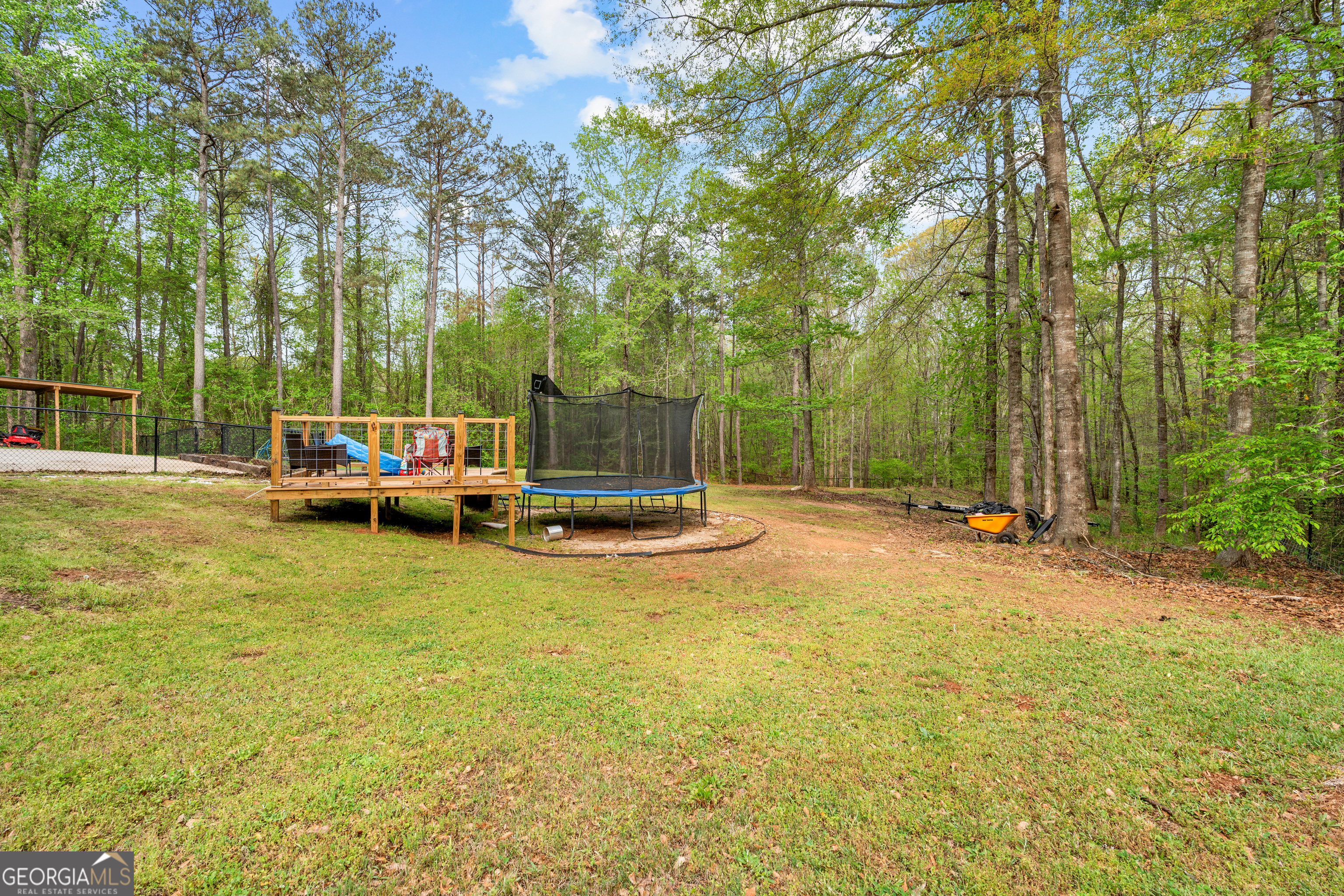 35 South Robin Lane Newnan, GA 30263 - Photo 48 of 50 a view of a swimming pool with lawn chairs and wooden fence