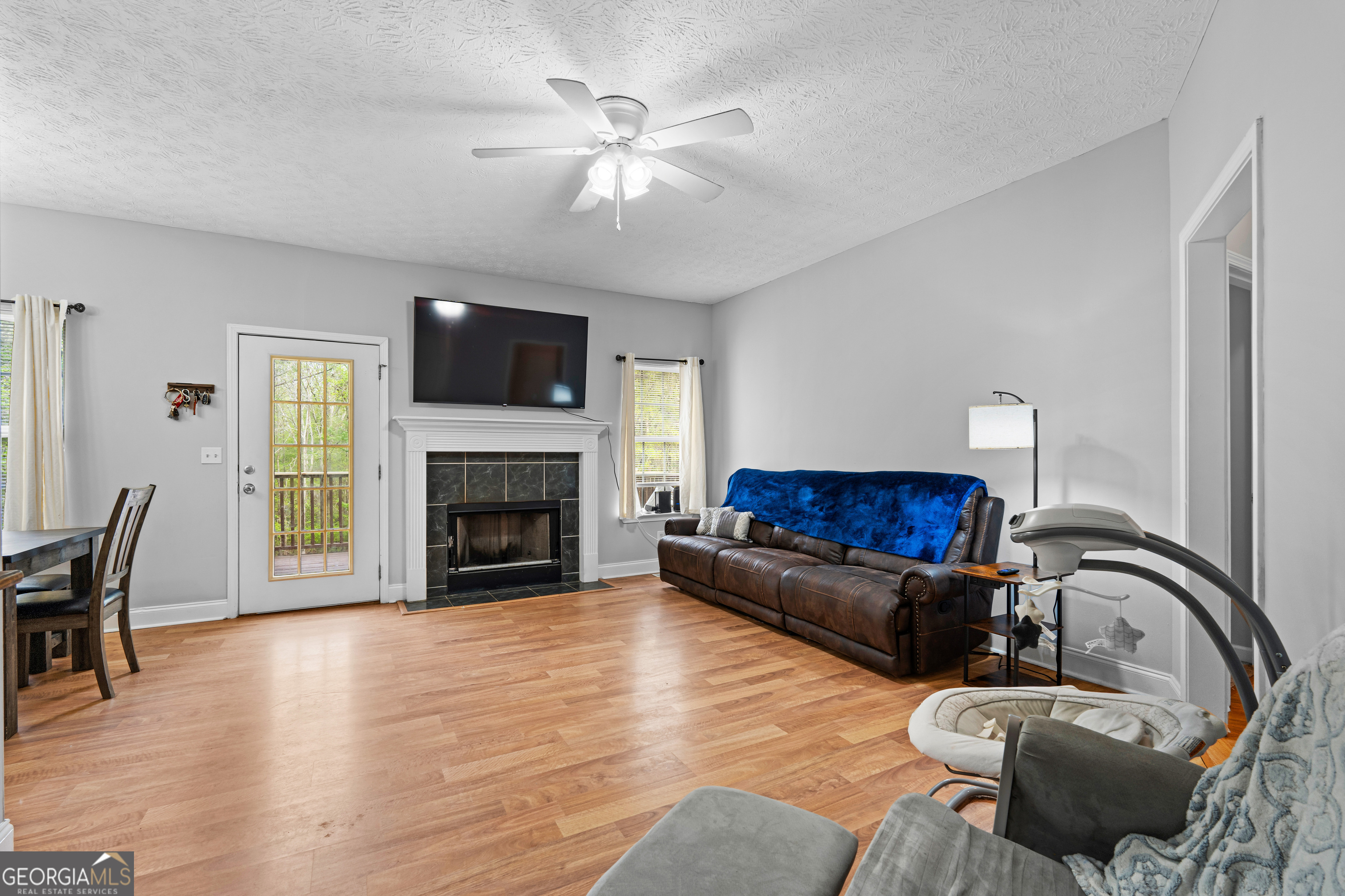 35 South Robin Lane Newnan, GA 30263 - Photo 7 of 50 a living room with furniture a flat screen tv and a fireplace