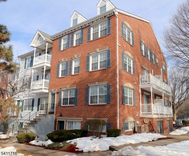 12 Rutgers Drive, Unit 12 Newark, NJ 07103 - Photo 1 of 22 a front view of a building with lot of cars and trees