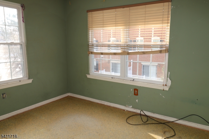 12 Rutgers Drive, Unit 12 Newark, NJ 07103 - Photo 19 of 22 a room with a chair and a window