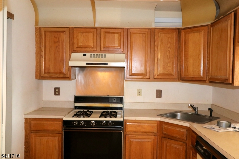 12 Rutgers Drive, Unit 12 Newark, NJ 07103 - Photo 7 of 22 a kitchen with stainless steel appliances granite countertop a stove a sink and a microwave