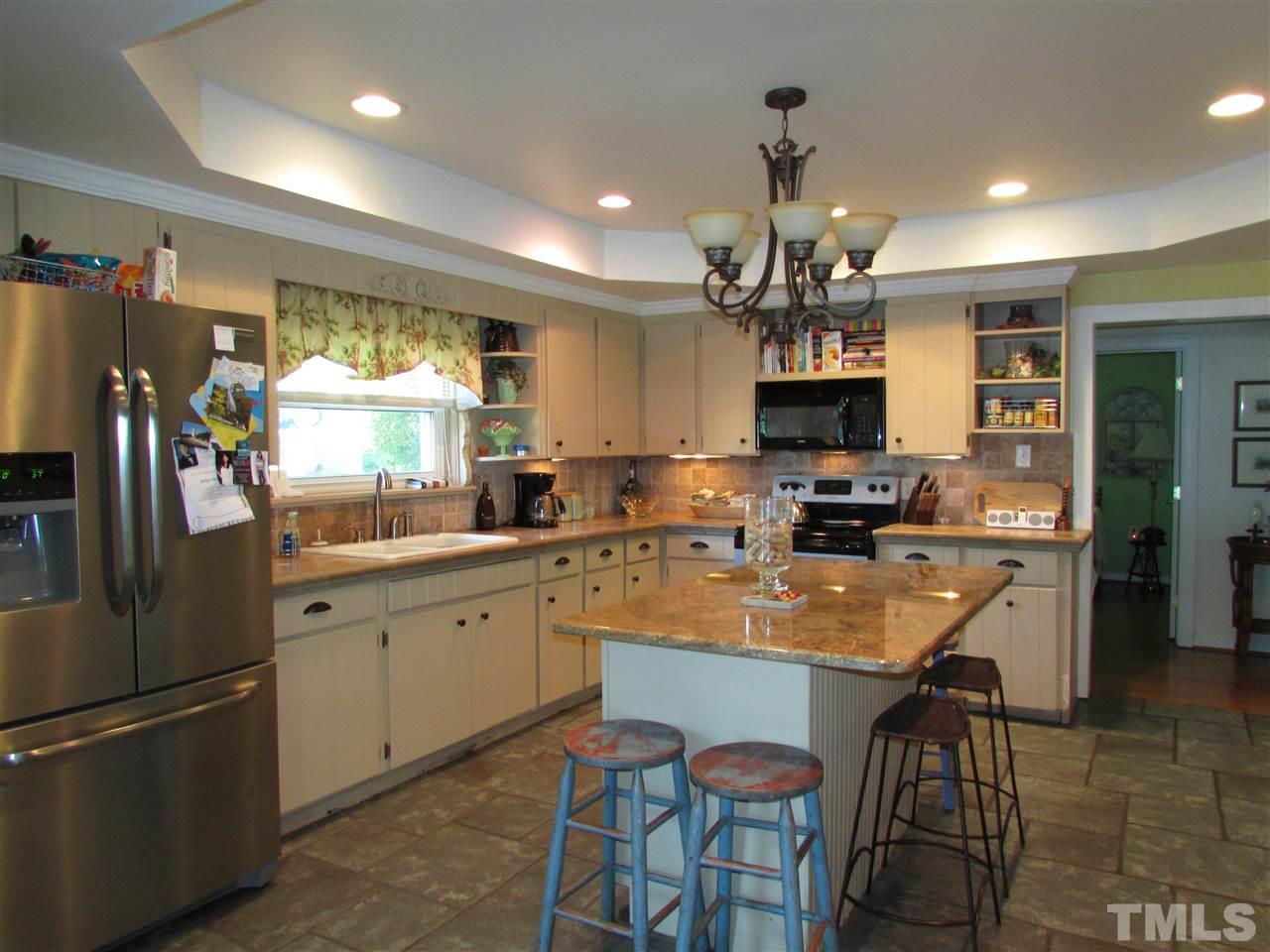 1231 Chambers Loop Road Timberlake, NC 27583 - Photo 5 of 22 Kitchen was remodeled with lots of tile, tray ceiling with recessed lighting. The stainless refrigerator in the picture will be replaced with a side by side stainless refrigerator