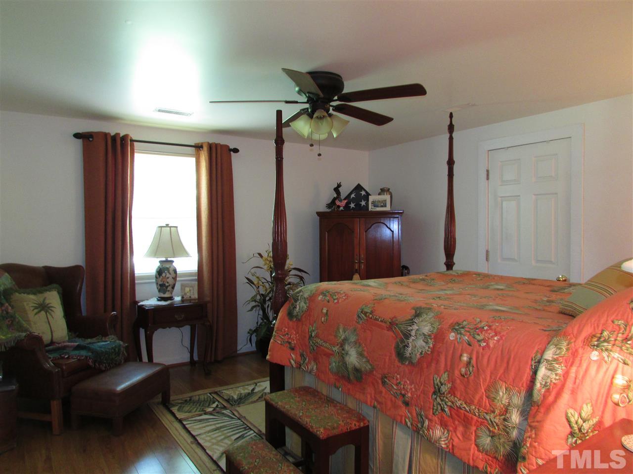 1231 Chambers Loop Road Timberlake, NC 27583 - Photo 10 of 22 The master bedroom has new laminate flooring and a huge cedar chip board walk in closet