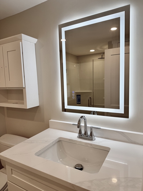 15 River Street, Unit 1 Beverly, MA 01915 - Photo 16 of 17 a bathroom with a sink and a mirror