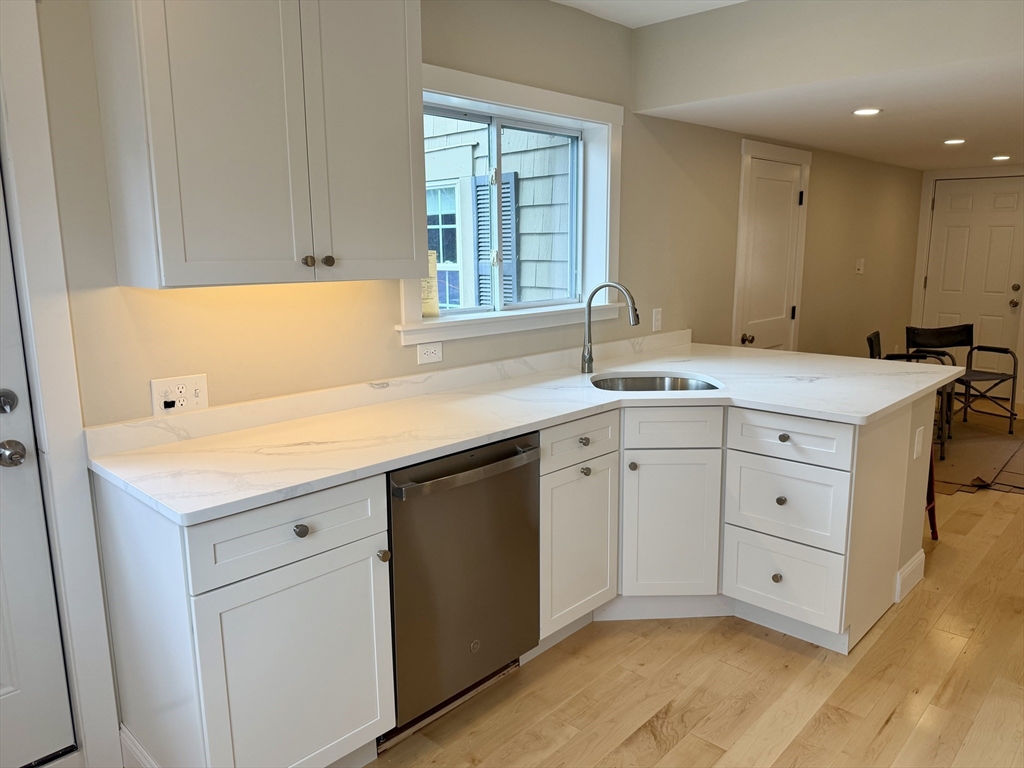 15 River Street, Unit 1 Beverly, MA 01915 - Photo 3 of 17 a kitchen with a sink cabinets and window
