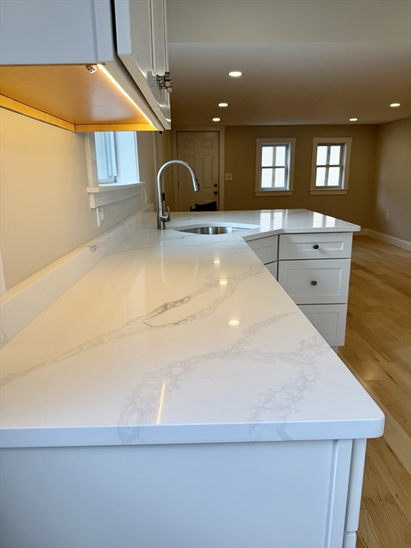 15 River Street, Unit 1 Beverly, MA 01915 - Photo 4 of 17 a bathroom with a sink a mirror and a bathtub