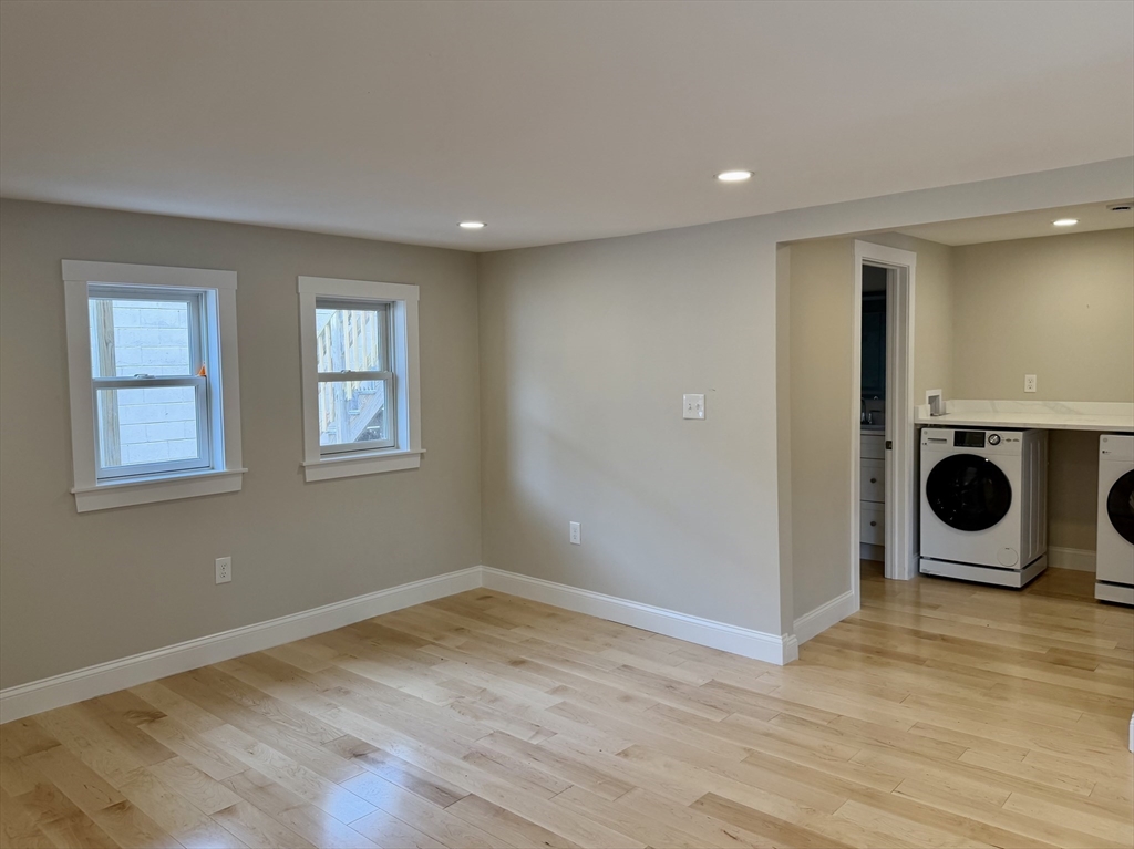 15 River Street, Unit 1 Beverly, MA 01915 - Photo 10 of 17 a view of a room with wooden floor and window