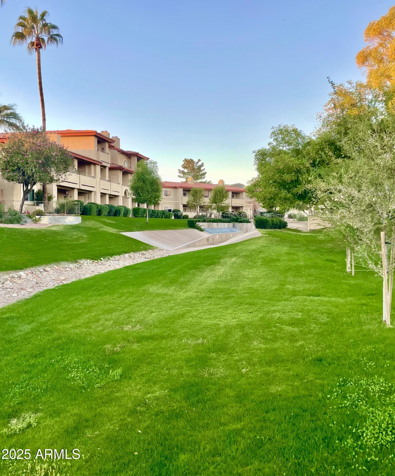 10410 North Cave Creek Road, Unit 2005 Phoenix, AZ 85020 - Photo 20 of 22 a view of a big house with a big yard and potted plants