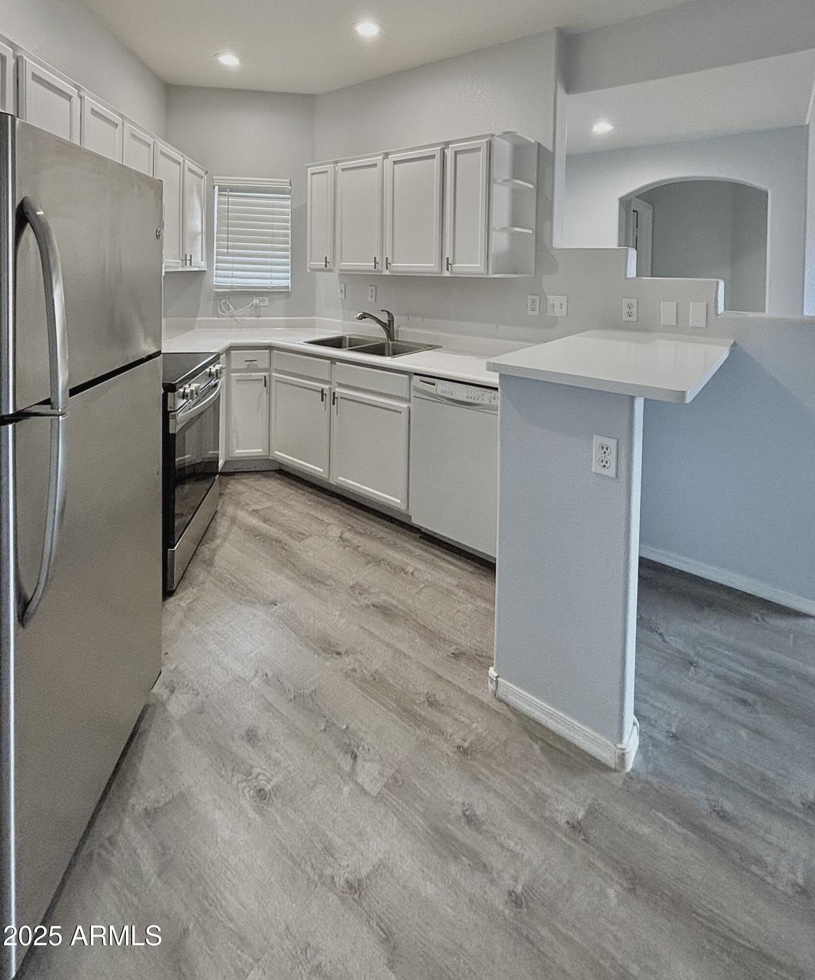 10410 North Cave Creek Road, Unit 2005 Phoenix, AZ 85020 - Photo 2 of 22 a kitchen with stainless steel appliances granite countertop a sink stove and refrigerator