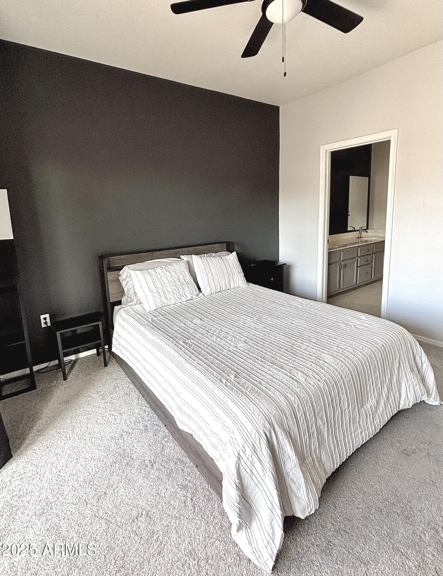10410 North Cave Creek Road, Unit 2005 Phoenix, AZ 85020 - Photo 6 of 22 a bedroom with a bed and a ceiling fan
