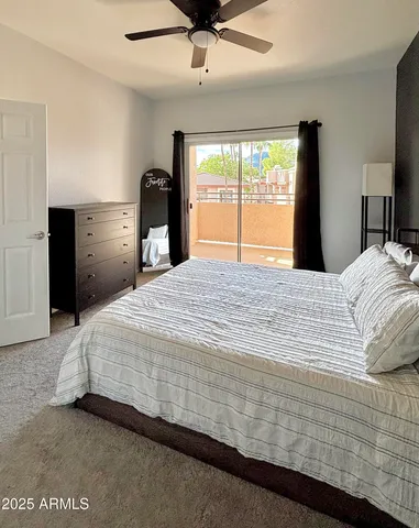 a bedroom with a bed and a large window