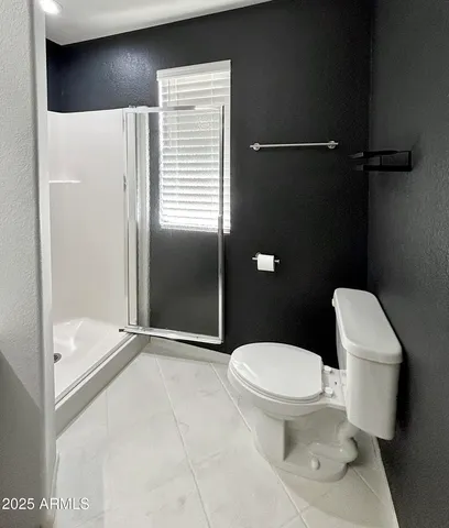a white toilet sitting next to a bathroom sink