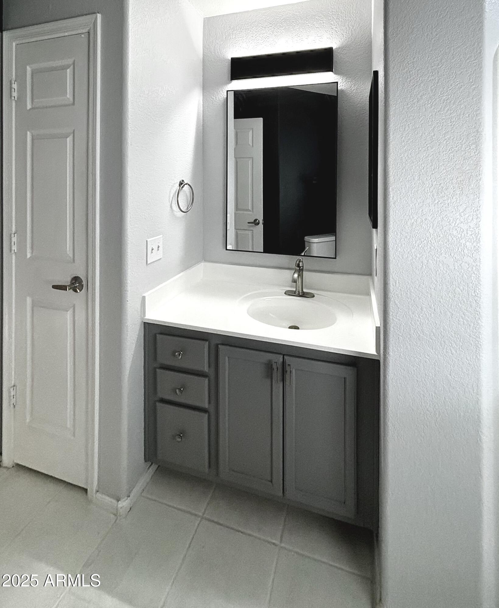10410 North Cave Creek Road, Unit 2005 Phoenix, AZ 85020 - Photo 10 of 22 a bathroom with a sink and a mirror