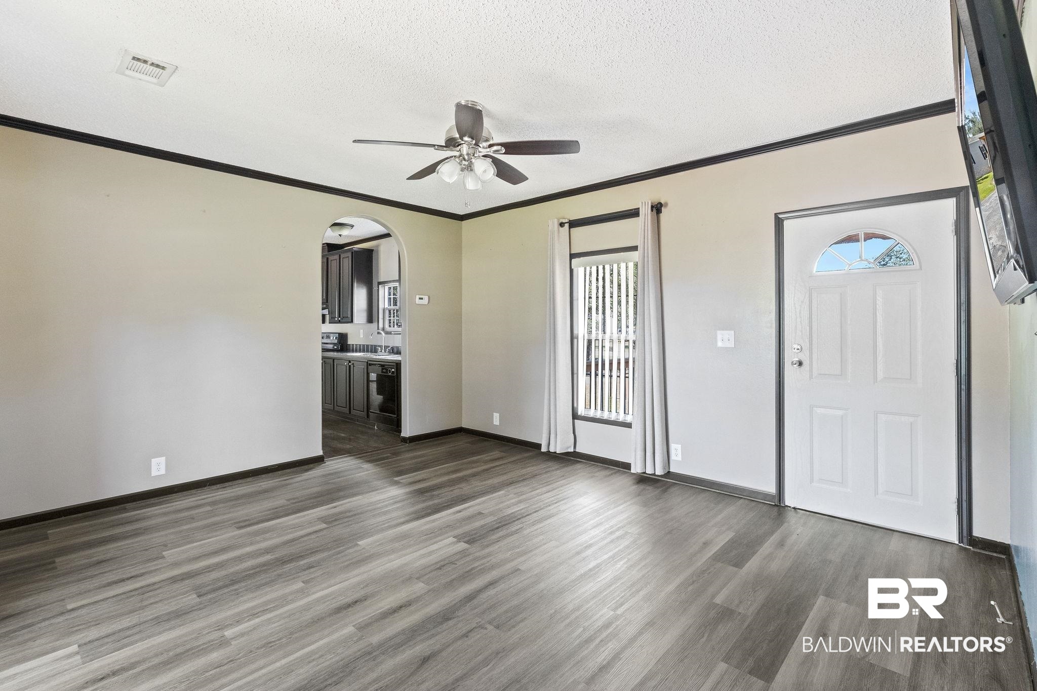 6870 Cecilia Court Theodore, AL 36582 - Photo 17 of 83 Entryway with dark wood-type flooring, a wealth of natural light, and a textured ceiling