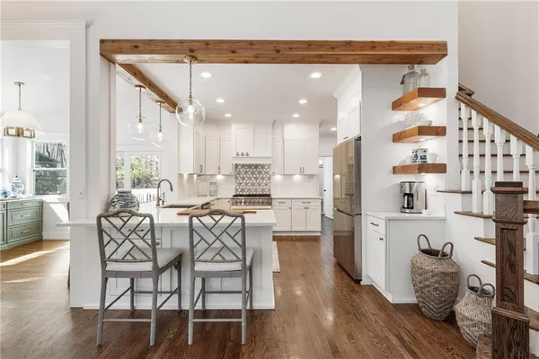 a view of a patio with a table and chairs and wooden floor