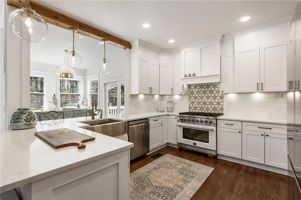 a bathroom with a granite countertop sink toilet and a mirror