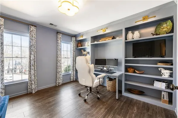a living room with furniture windows and wooden floor