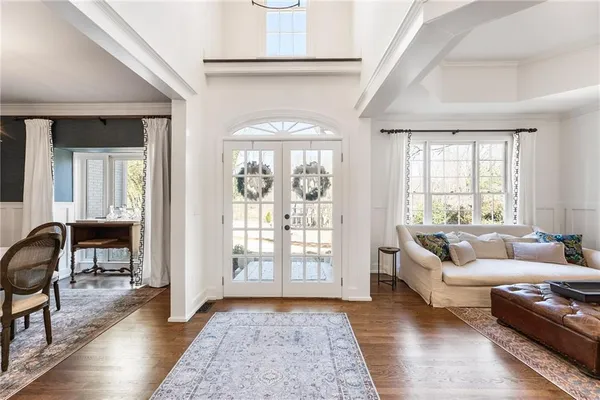 a living room with furniture a flat screen tv and a window