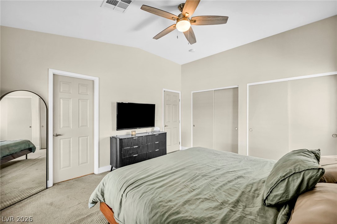1234 Sunfire Street Henderson, NV 89014 - Photo 15 of 40 A comfortable bedroom features plush carpeting and a modern ceiling fan, ensuring relaxation.