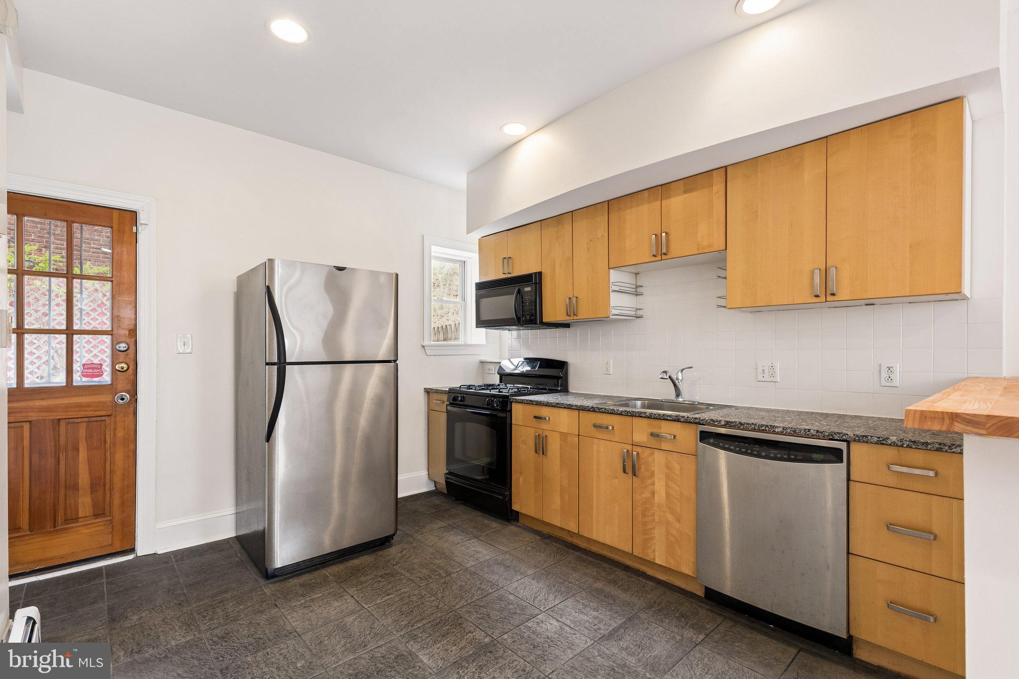 714 South 18th Street Philadelphia, PA 19146 - Photo 11 of 28 a kitchen with stainless steel appliances granite countertop a refrigerator and a sink