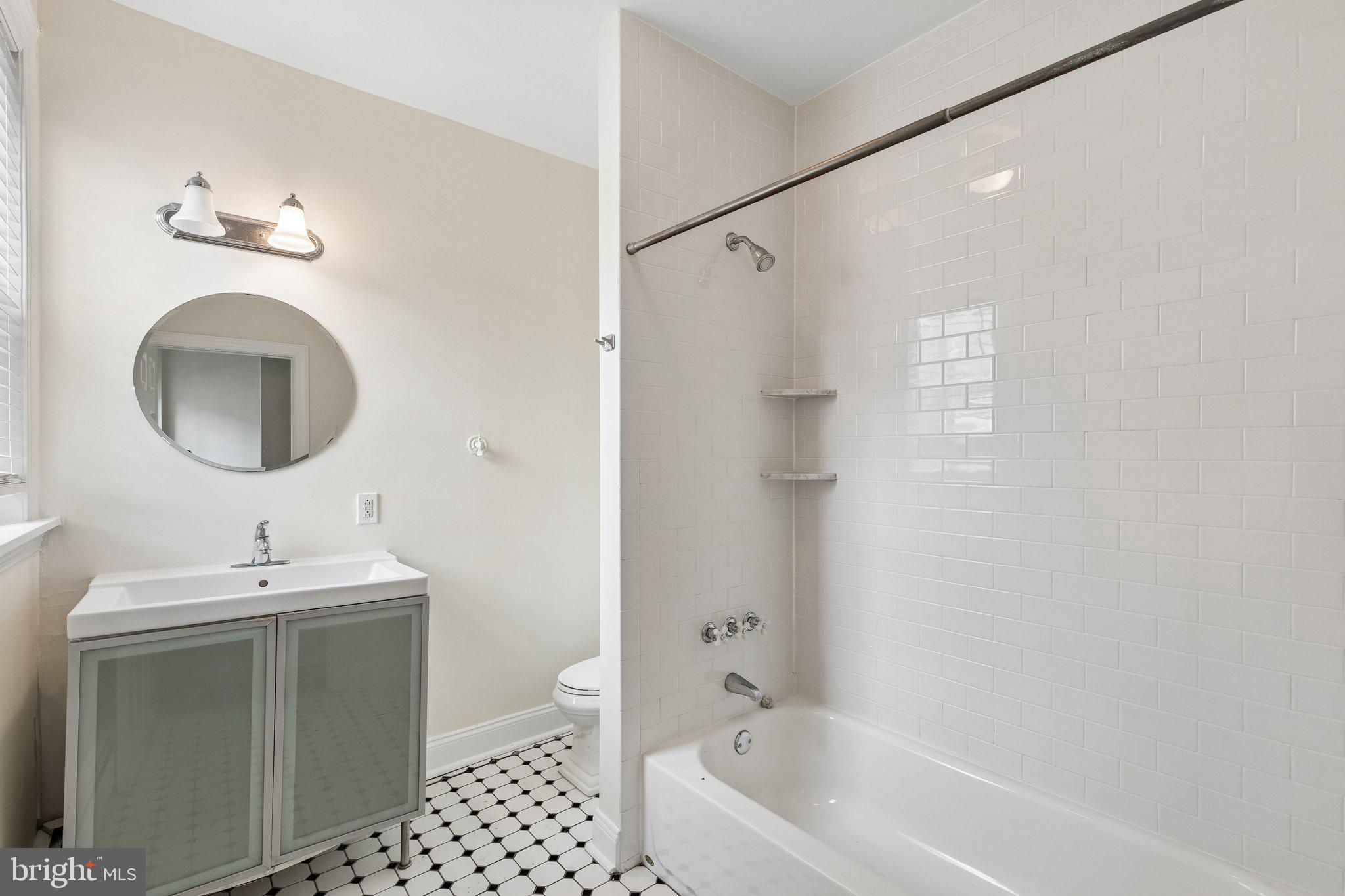714 South 18th Street Philadelphia, PA 19146 - Photo 13 of 28 a bathroom with a sink a toilet and a mirror