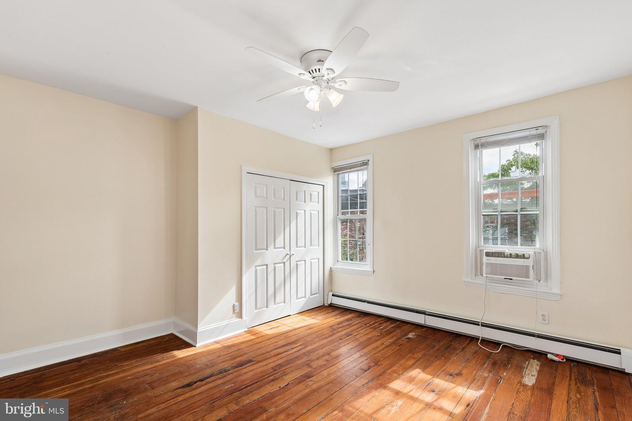 714 South 18th Street Philadelphia, PA 19146 - Photo 16 of 28 an empty room with wooden floor chandelier fan and windows