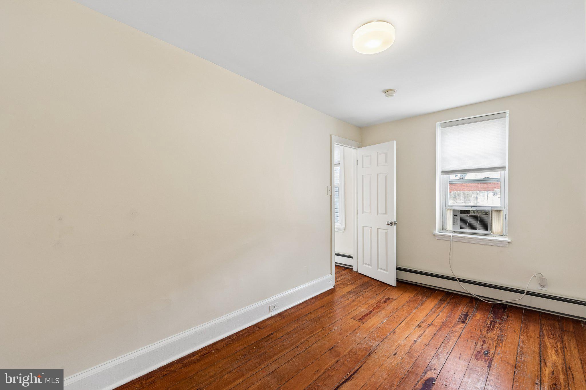 714 South 18th Street Philadelphia, PA 19146 - Photo 17 of 28 an empty room with wooden floor and windows