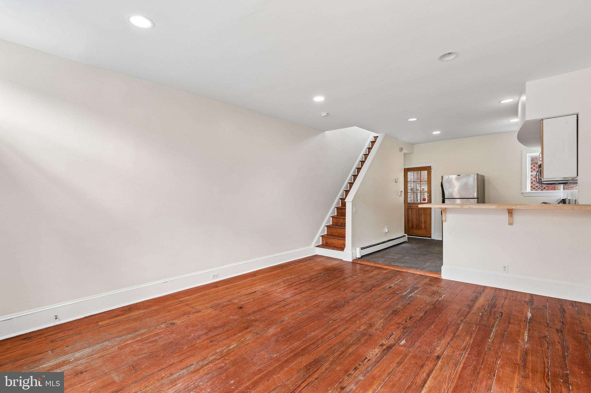 714 South 18th Street Philadelphia, PA 19146 - Photo 6 of 28 a view of a kitchen with wooden floor and stairs