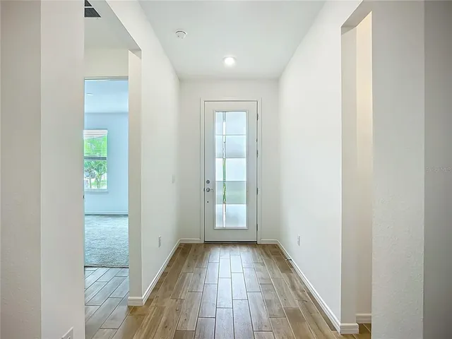 a view of hallway with wooden floor