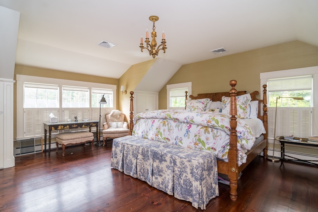 97 Maple Street Sherborn, MA 01770 - Photo 10 of 25 a bedroom with a bed and wooden floor