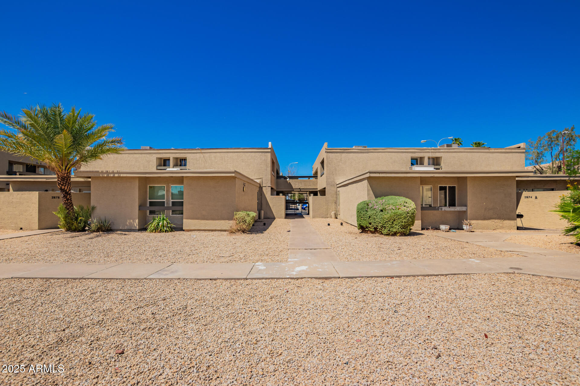 2674 North 43rd Avenue, Unit D Phoenix, AZ 85009 - Photo 1 of 19 a view of a house with a road