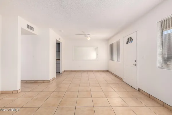a kitchen with white cabinets sink and stove