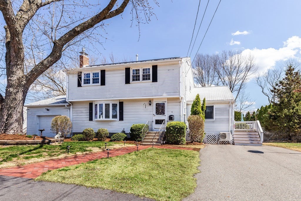 a front view of house with yard and outdoor seating