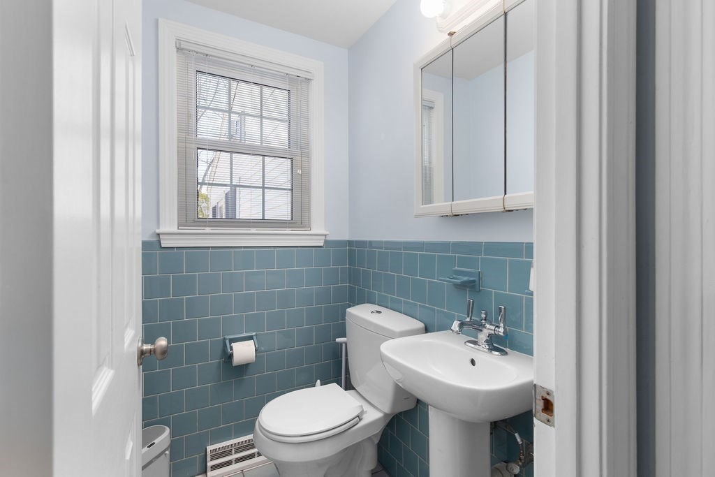 71 Pond Lane Randolph, MA 02368 - Photo 17 of 35 a bathroom with a toilet sink and mirror