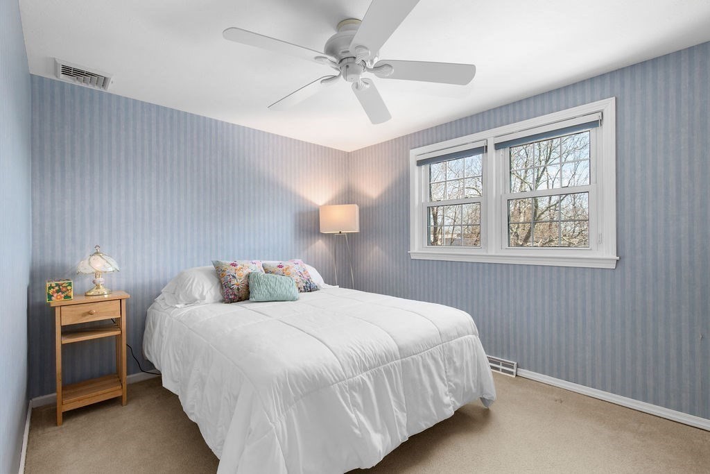 71 Pond Lane Randolph, MA 02368 - Photo 20 of 35 a bedroom with a bed and a tv