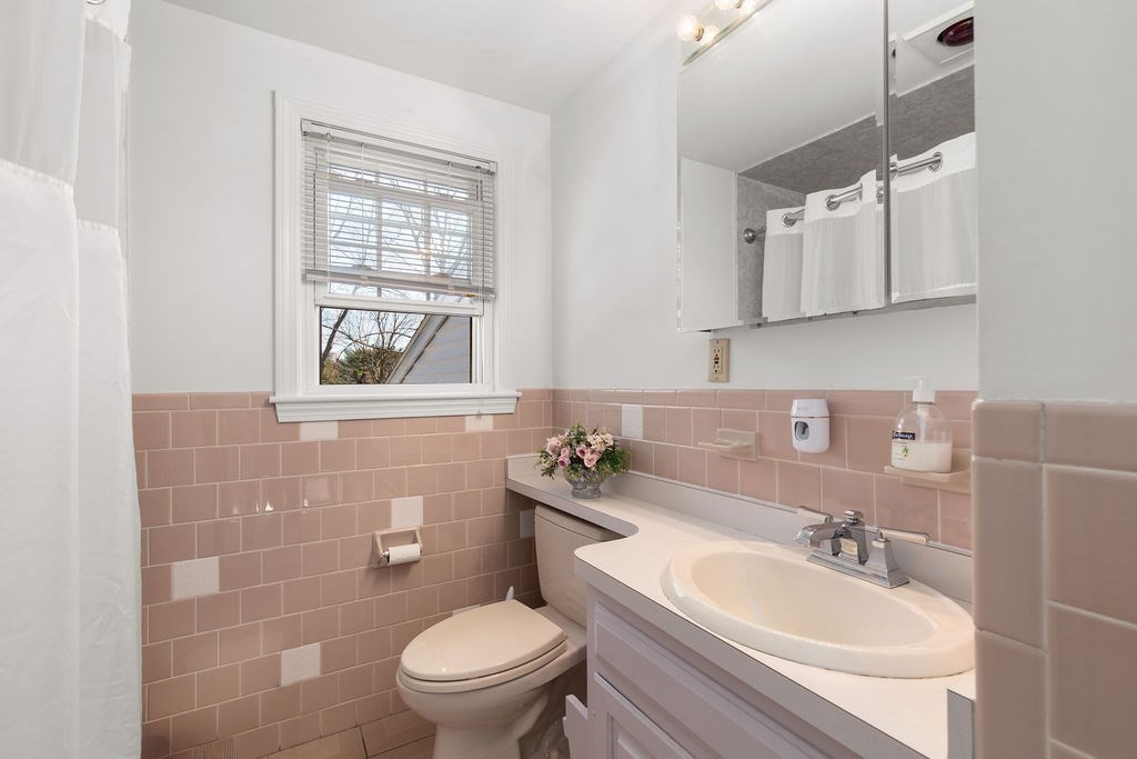 71 Pond Lane Randolph, MA 02368 - Photo 22 of 35 a bathroom with a sink a toilet and mirror